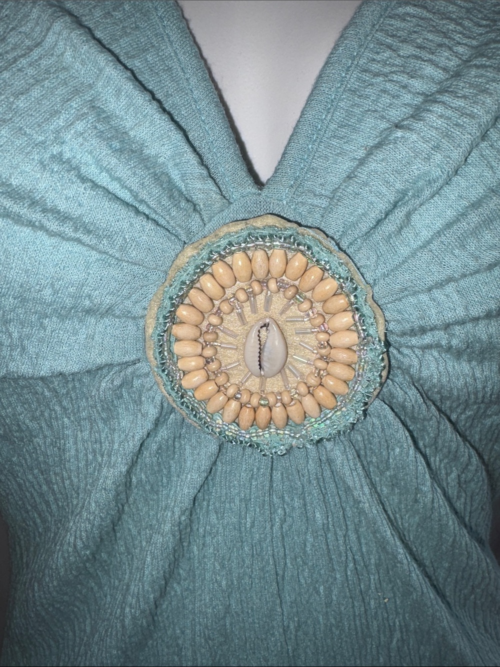 Susan Lawrence Teal Short Sleeve Top with Decorative Shell Medallion